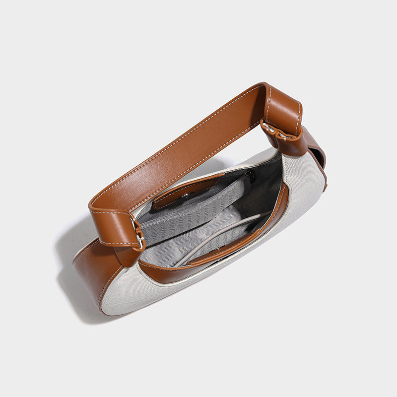 Bolsode media luna. Diseño moderno, minimalista y elegante, ideal para llevar al hombro en un look casual chic. Perfecto para el día a día