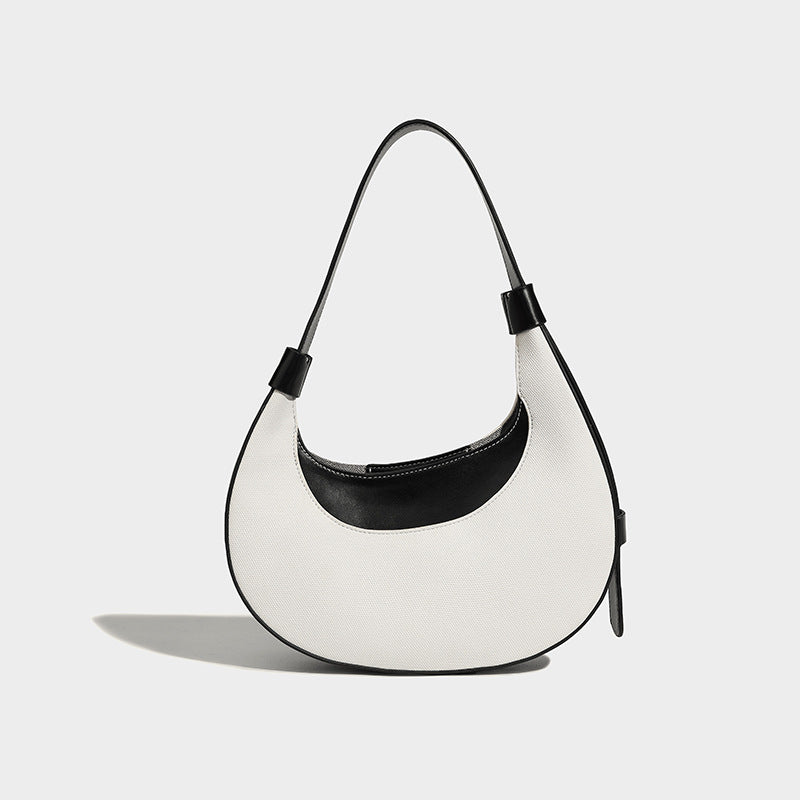 Bolsode media luna. Diseño moderno, minimalista y elegante, ideal para llevar al hombro en un look casual chic. Perfecto para el día a día